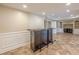 Finished basement offers a wet bar, recessed lighting, and tile flooring at 5825 Laurel Oak Dr, Suwanee, GA 30024