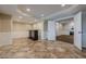 Finished basement with tile flooring, recessed lighting, wet bar, and open layout at 5825 Laurel Oak Dr, Suwanee, GA 30024
