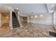 Spacious finished basement with tile flooring, paneled walls and a staircase to main floor at 5825 Laurel Oak Dr, Suwanee, GA 30024