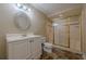 Bathroom featuring white vanity, toilet, and tiled shower with glass doors at 5825 Laurel Oak Dr, Suwanee, GA 30024