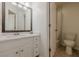 This bright bathroom features a vanity with marble countertop and a shower with white tiling at 5825 Laurel Oak Dr, Suwanee, GA 30024