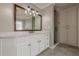 Modern bathroom with a spacious vanity, framed mirror, and enclosed shower at 5825 Laurel Oak Dr, Suwanee, GA 30024