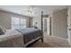 This bedroom features neutral walls, carpet, and a large window for natural light at 5825 Laurel Oak Dr, Suwanee, GA 30024