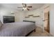 Bedroom showcasing neutral walls, built-in shelving, and an open doorway to the upstairs hallway at 5825 Laurel Oak Dr, Suwanee, GA 30024