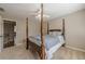 This bedroom features a four-poster bed, neutral walls, and a ceiling fan with a light at 5825 Laurel Oak Dr, Suwanee, GA 30024