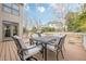 This is a back deck with seating, overlooking the yard, water feature, and the home at 5825 Laurel Oak Dr, Suwanee, GA 30024