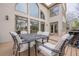 Seating on the deck overlooking the back yard and a home with arched windows at 5825 Laurel Oak Dr, Suwanee, GA 30024