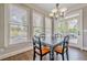 Dining area with hardwood floors, chandelier, and access to a patio via the french doors at 5825 Laurel Oak Dr, Suwanee, GA 30024