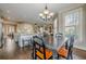 Open concept dining area with hardwood floors, connecting to kitchen and living room, filled with natural light at 5825 Laurel Oak Dr, Suwanee, GA 30024