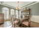 Traditional dining room with a wooden table, chairs, arched windows, and a vintage china cabinet at 5825 Laurel Oak Dr, Suwanee, GA 30024