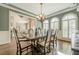 Charming dining room with hardwood floors, a chandelier, and arched windows with shutter blinds at 5825 Laurel Oak Dr, Suwanee, GA 30024
