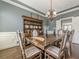 Dining room with vintage furniture, chandelier, blue walls, white trim, and hardwood floors at 5825 Laurel Oak Dr, Suwanee, GA 30024