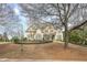 Two-story home with stone accents, surrounded by mature landscaping and a spacious front yard at 5825 Laurel Oak Dr, Suwanee, GA 30024