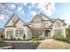 Elegant two-story home with stone accents and meticulously landscaped front yard at 5825 Laurel Oak Dr, Suwanee, GA 30024