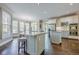 Spacious kitchen featuring hardwood floors, an island with seating, stainless steel appliances, and natural light at 5825 Laurel Oak Dr, Suwanee, GA 30024