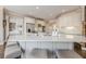 Open concept kitchen with a large island and seating, hardwood floors, and stone countertops at 5825 Laurel Oak Dr, Suwanee, GA 30024
