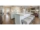 Kitchen with hardwood floors, island with seating, stainless steel appliances, and an open view of the living room at 5825 Laurel Oak Dr, Suwanee, GA 30024