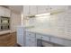 Office space in kitchen with white cabinets, marble countertops, and stainless steel double ovens at 5825 Laurel Oak Dr, Suwanee, GA 30024
