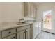 Well-equipped laundry room with ample counter space, cabinets, and a utility sink at 5825 Laurel Oak Dr, Suwanee, GA 30024