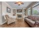 Bright living room boasts a fireplace, built-in shelving, and large windows at 5825 Laurel Oak Dr, Suwanee, GA 30024