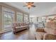 Open-concept living room features a large window area and seamlessly connects to the kitchen at 5825 Laurel Oak Dr, Suwanee, GA 30024