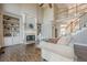 Bright living room with hardwood floors, fireplace, built-in bookshelves, and an open staircase to a second story at 5825 Laurel Oak Dr, Suwanee, GA 30024