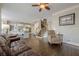 Bright open space showing living room, kitchen and staircase with hardwood floors throughout at 5825 Laurel Oak Dr, Suwanee, GA 30024
