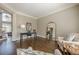 Bright living room with hardwood floors, decorative mirror, table and chair at 5825 Laurel Oak Dr, Suwanee, GA 30024