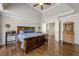 Main bedroom with hardwood floors, tray ceiling, and neutral color palette at 5825 Laurel Oak Dr, Suwanee, GA 30024