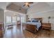 Bright main bedroom boasts hardwood floors, a ceiling fan, and large windows at 5825 Laurel Oak Dr, Suwanee, GA 30024