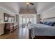 Charming main bedroom featuring hardwood floors, tray ceiling, and ample natural light at 5825 Laurel Oak Dr, Suwanee, GA 30024