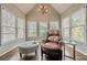 Inviting sitting room with hardwood floors, a leather armchair, and natural light at 5825 Laurel Oak Dr, Suwanee, GA 30024