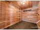 Spacious wood-paneled walk-in closet with custom shelving and ample storage space at 5825 Laurel Oak Dr, Suwanee, GA 30024