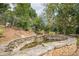 This backyard has an artificial stone water feature, full of lush greenery at 5825 Laurel Oak Dr, Suwanee, GA 30024
