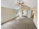 Spacious main bedroom featuring vaulted ceilings, carpet, a ceiling fan, and two windows at 624 Ironstone Dr, Fairburn, GA 30213