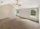 Large main bedroom featuring carpet, a ceiling fan, and large windows providing natural light at 624 Ironstone Dr, Fairburn, GA 30213