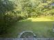 Spacious backyard with lush green grass and mature trees at 8538 Westchester Dr, Douglasville, GA 30134