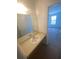 Bathroom vanity with a sink and a large mirror at 8538 Westchester Dr, Douglasville, GA 30134