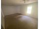 Bright bedroom featuring ceiling fans, a window, and a door at 8538 Westchester Dr, Douglasville, GA 30134