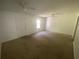 Bright bedroom featuring ceiling fans, a window, and a door at 8538 Westchester Dr, Douglasville, GA 30134