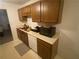 Functional kitchen with wood cabinets and white appliances, ready for culinary creations at 8538 Westchester Dr, Douglasville, GA 30134