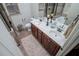 Bathroom featuring double sinks, tile floors, a decorative mirror, and modern fixtures at 95 Gorham Gates Dr, Hiram, GA 30141