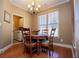 Cozy dining area with wood floors, chandelier, and natural light from the large window at 95 Gorham Gates Dr, Hiram, GA 30141