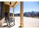 Inviting front porch with rocking chairs, stone accents and views of the neighborhood at 95 Gorham Gates Dr, Hiram, GA 30141