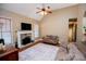 Cozy living room featuring a stone fireplace, vaulted ceiling and natural light at 95 Gorham Gates Dr, Hiram, GA 30141