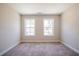 A cozy bedroom featuring plush carpeting and bright windows overlooking the neighborhood at 109 Priestwood Ln, Acworth, GA 30102