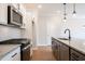 Modern kitchen with granite countertops, stainless steel appliances, and a gray island at 109 Priestwood Ln, Acworth, GA 30102