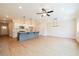 A spacious kitchen featuring a large gray island and stainless steel appliances in an open-concept living space at 109 Priestwood Ln, Acworth, GA 30102