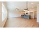 Spacious open-concept living room with a kitchen island, modern lighting, and luxury vinyl plank flooring at 109 Priestwood Ln, Acworth, GA 30102