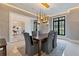 Dining room features a modern chandelier over a dark wood table with seating for six at 3968 Ashford Dunwoody, Brookhaven, GA 30319